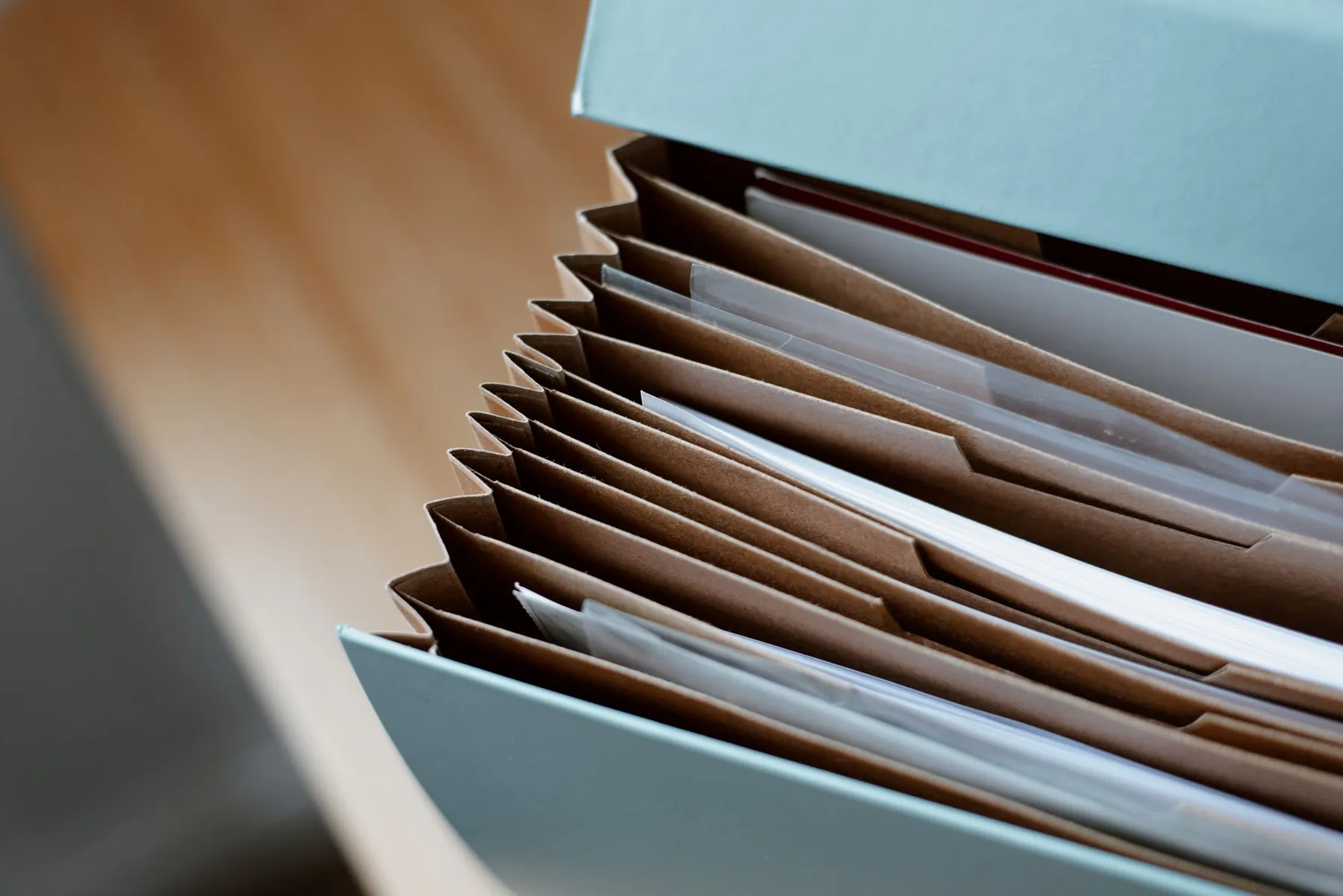 An accordion folder full of documents.