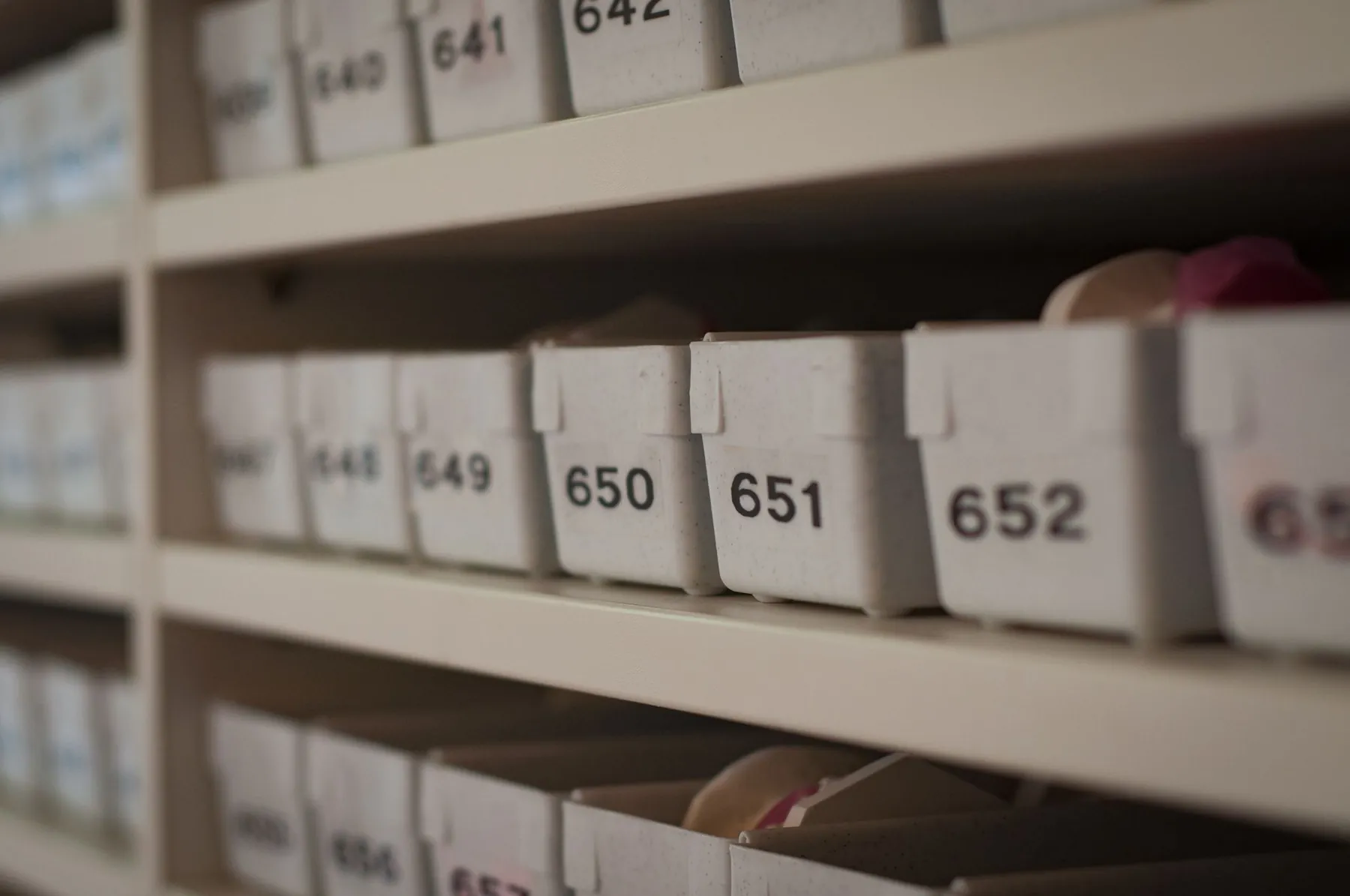 Numbered storage boxes lined up on shelves.