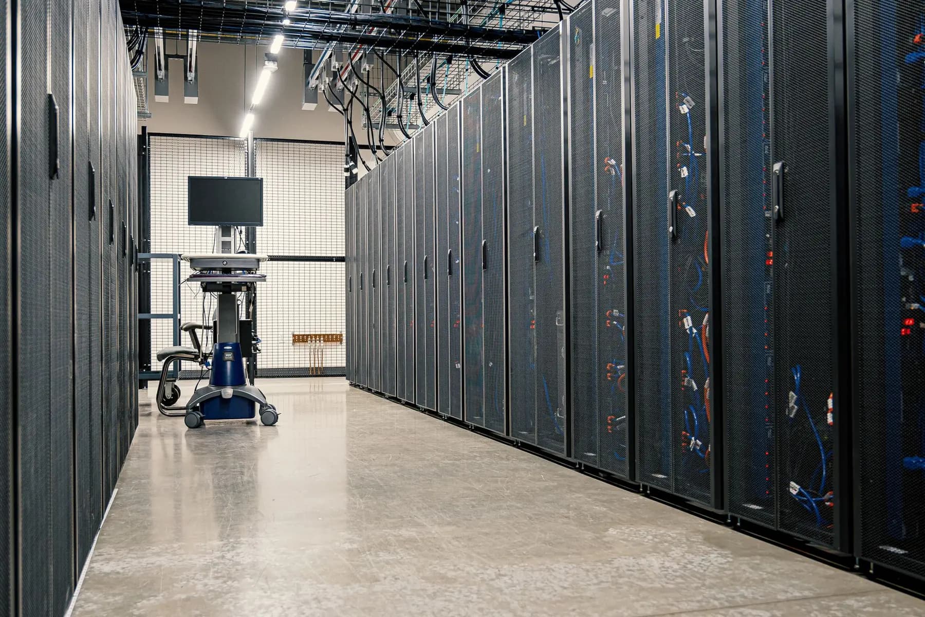 An aisle between server racks in a data center.