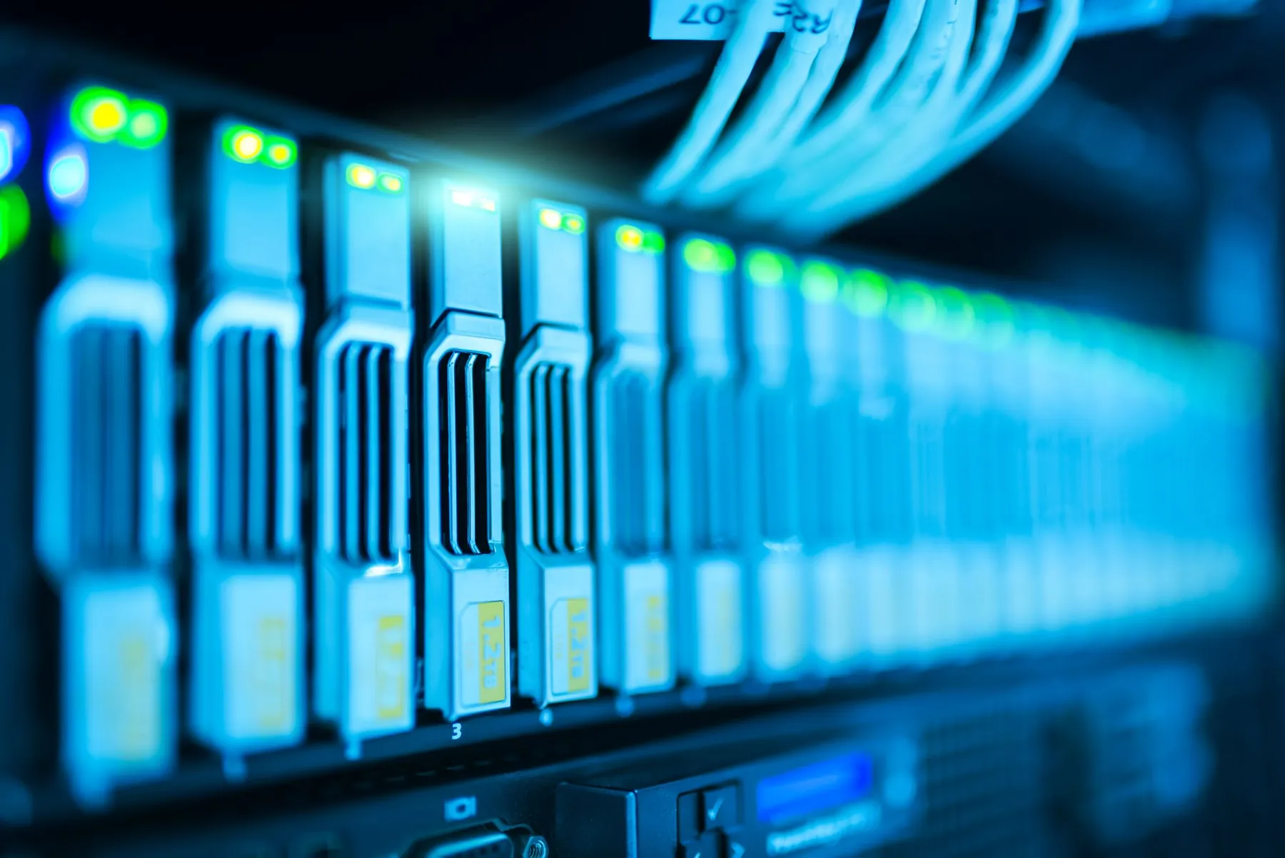 Rows of drive bays glowing blue in a server rack.