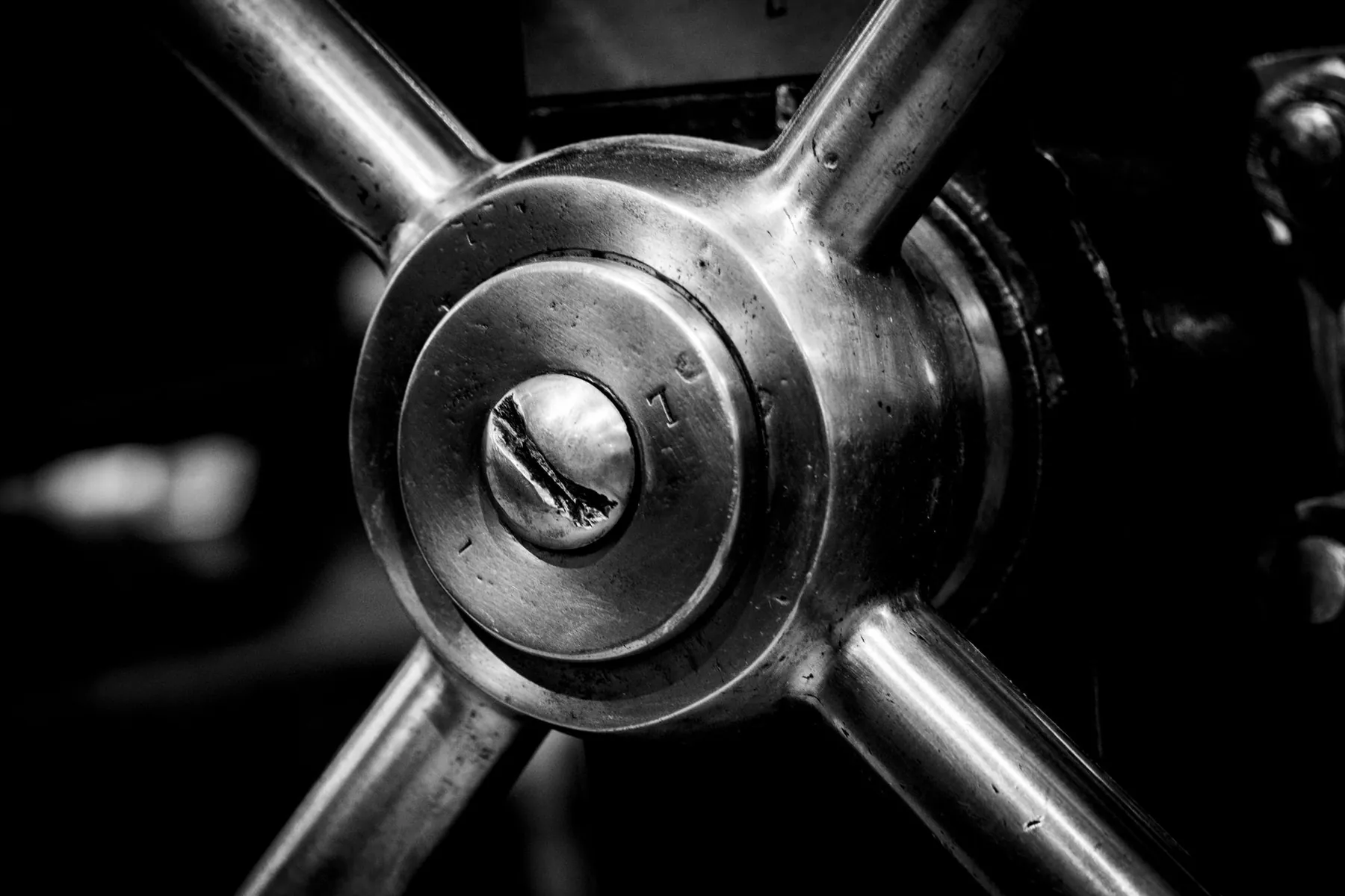A heavy steel handwheel, in black and white.